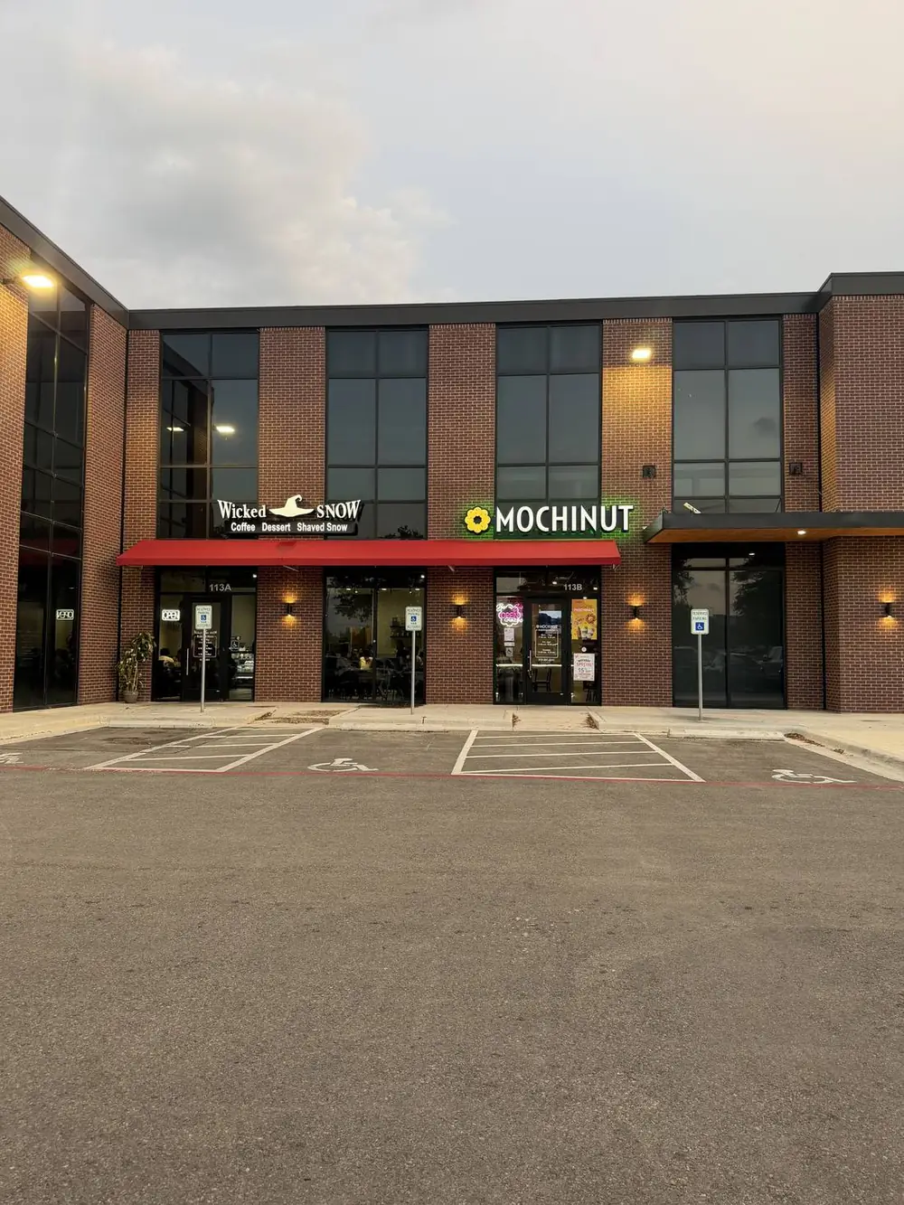 Daytime view of the Mochinut Cedar Park entrance, suite 113B, next to Wicked Snow